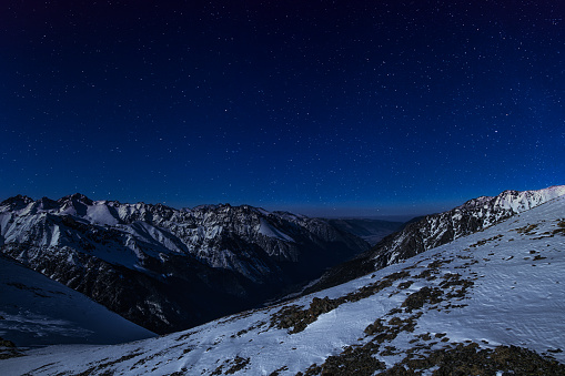 Majestic snowy mountain at night against stars