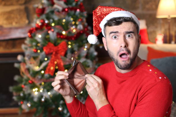 Man with empty wallet during Christmas stock photo