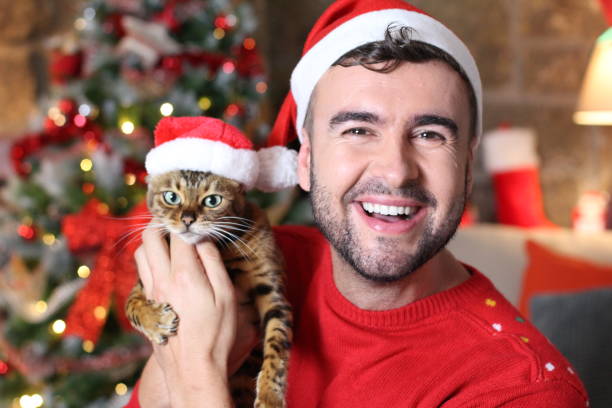 istock Cute man and his bengal cat during Christmas 1284789567