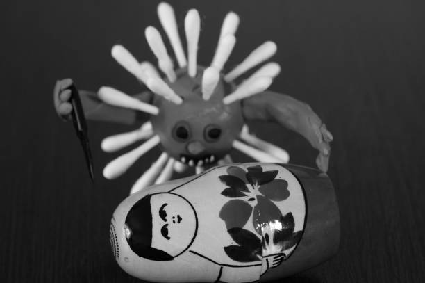 istock Virus figurine made of plasticine with a toy knife. 1284789603