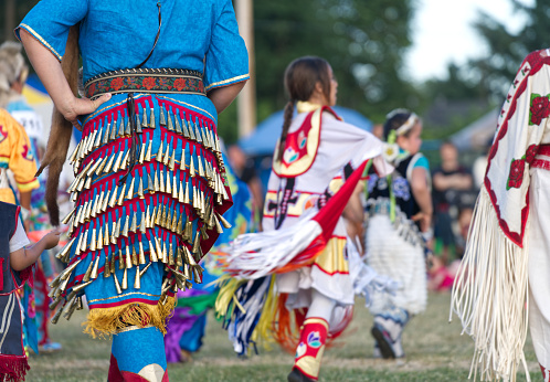 Capilano Reserve, West Vancouver, British Columbia, Canada — 8 July 2017. The Squamish Nation 30th Annual Powwow, gathering of First Nations communities to honour their culture, share, respect, dance and drum. This is an example of exquisite regalia.