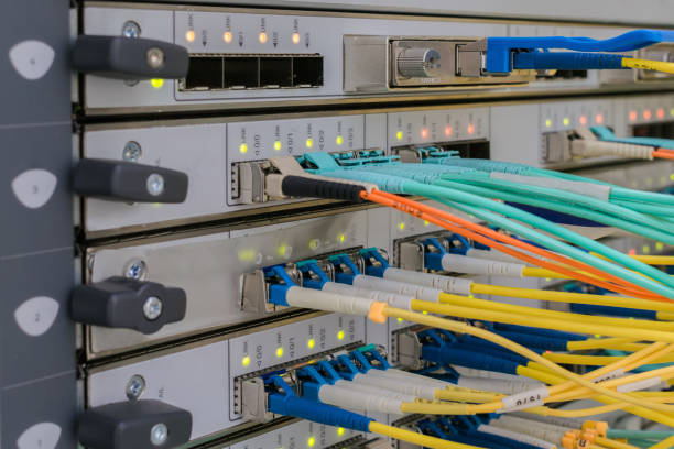 There are high speed central router interfaces in the server room. Fiber optic data transmission wires. Modern cable internet connection.