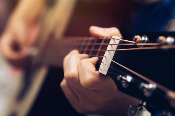 istock Close-up hands and tuning of the guitar player 1284792872