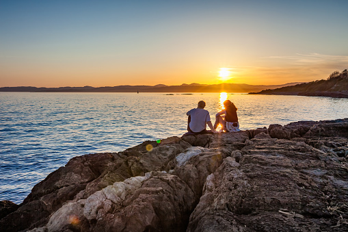 Couple enjoys sunset in Victoria, British Columbia, Canada on a clear sky day.
