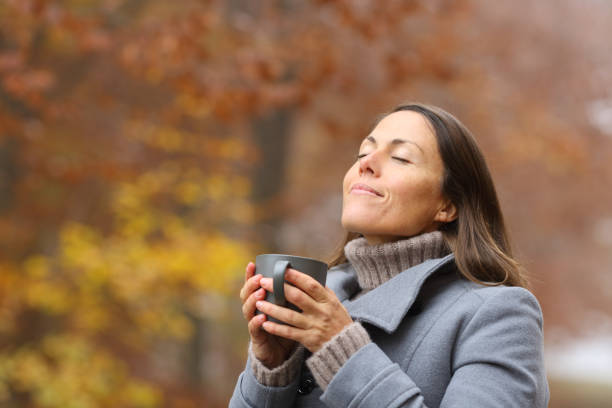 istock Relaxed middle age woman with coffee breathing in fall 1284795203