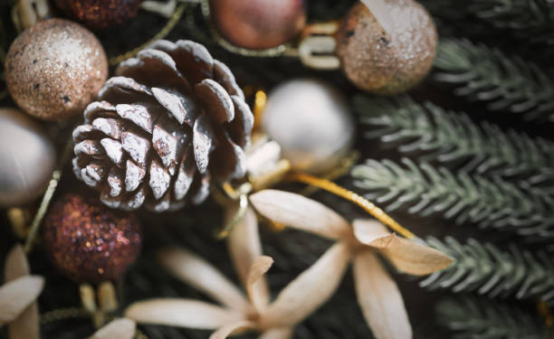 istock Pine cone and christmas decoration balls on dark wood. 1284795262