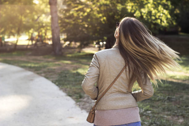 istock Woman walking at sunset 1284795569