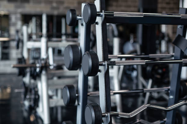 istock Dumbbells in row on equipment stand in modern gym 1284795815