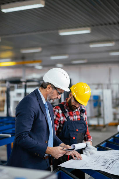 istock Young engineer with quality control inspector in factory stock photo 1284796607