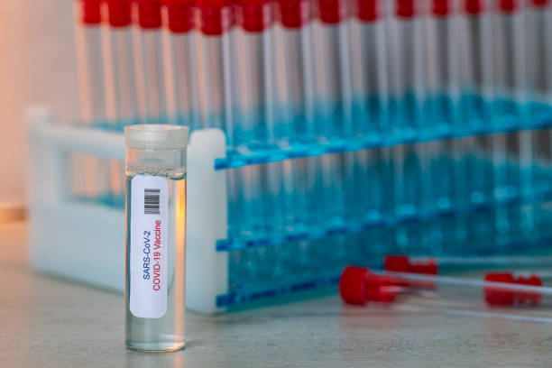 istock Coronavirus Vaccine with Test Tubes in Background 1284796636
