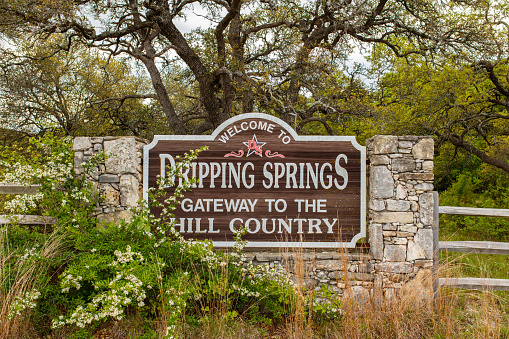 Dripping Springs, Texas USA - April 6, 2016: Welcome to Dripping Springs sign from this small town in the Texas Hill Country.