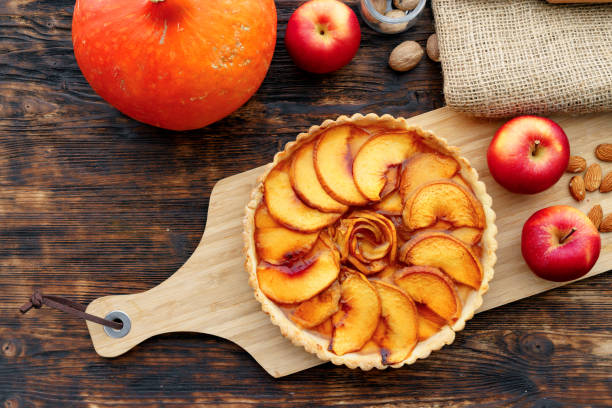 istock Apple tart pie and red apples on wooden table 1284797954