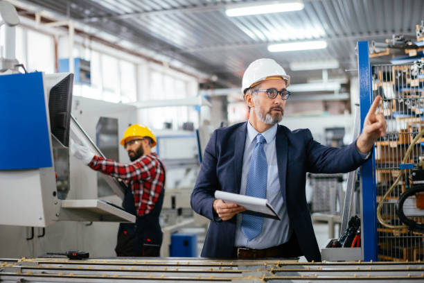 istock Young engineer with quality control inspector in factory stock photo 1284798582