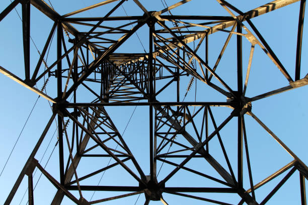 istock Electric power pylon and overhead lines tower used transmit electrical energy 1284799119