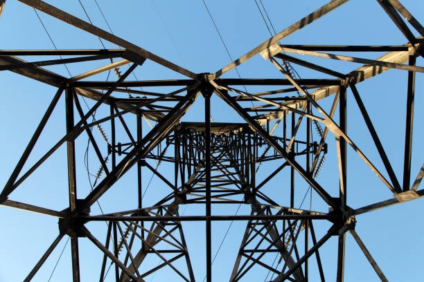 istock Electric power pylon and overhead lines tower used transmit electrical energy 1284799156