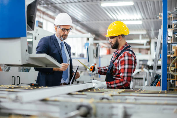istock Young engineer with quality control inspector in factory stock photo 1284799234