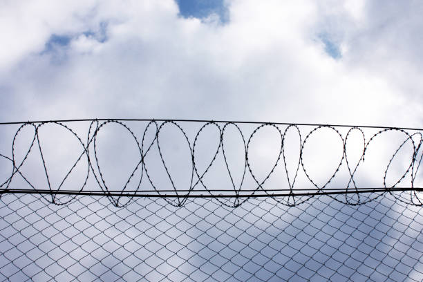 istock Security Fence used at a Prison Facility, barbed wire, secure facility, prison 1284799242