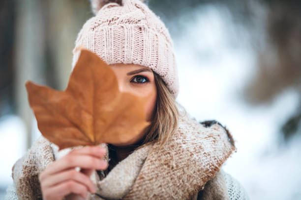 istock Woman holding autumn leaf 1284799449