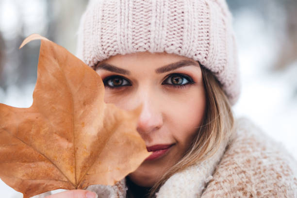 istock Woman holding autumn leaf 1284799465
