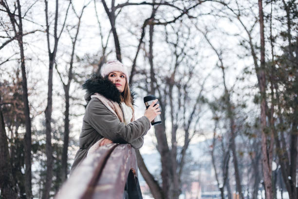 istock Woman drinking coffee on bridge 1284799706