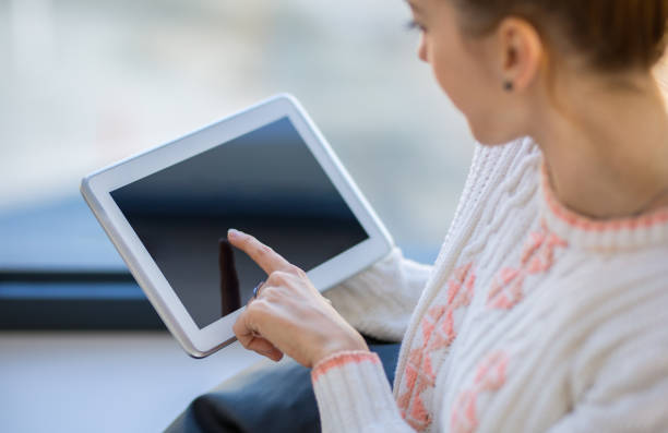 istock Female Entrepreneur holding tablet and sitting in modern office 1284799867