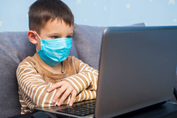 istock Distance learning online education. A schoolboy boy studies at home and does his school homework. A home distance learning 1284801245