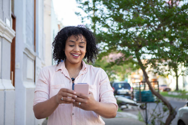 istock Woman using smartphone in the street. Online date concept. 1284802182