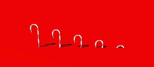istock 3D illustration/ rendering of five red and white candy cane sticks/lollipops gradually protruding out of red background. 1284805273