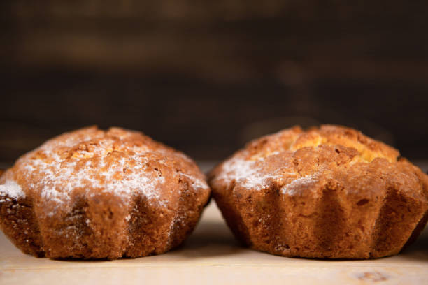 istock Freshly baked delicious cupcakes on a wooden table. 1284807233