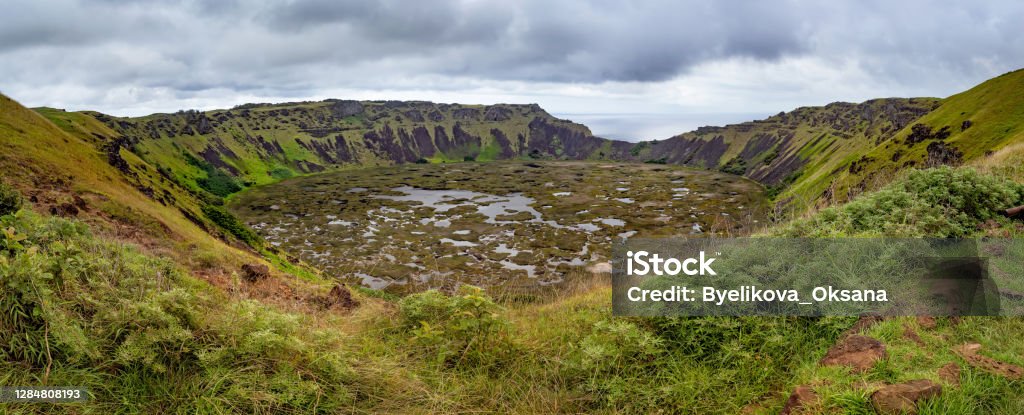 View at volcano crater Rano Kau on Easter Island, Chile Panoramic View at volcano crater Rano Kau on Easter Island, Chile Kau District Stock Photo