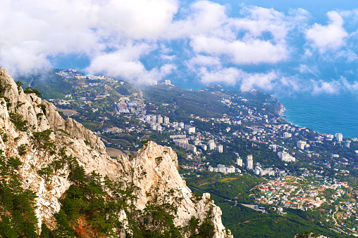 View on the mountain peak and town by the blue sea coast in Crimea