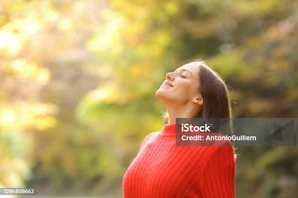 Woman In Red Breathing Fresh Air In Autumn In A Forest Stock Photo - Download Image Now