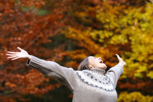 istock Excited woman celebrating autumn stretching arms 1284809169