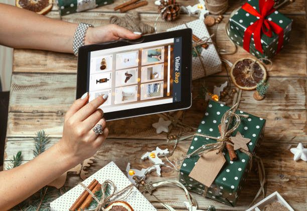 istock Female hands with tablet on table with hand made christmas decor 1284809213