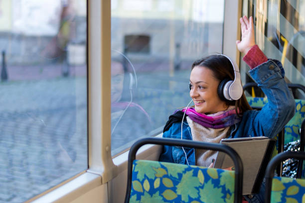 istock A beautiful young woman in public transport. 1284811432