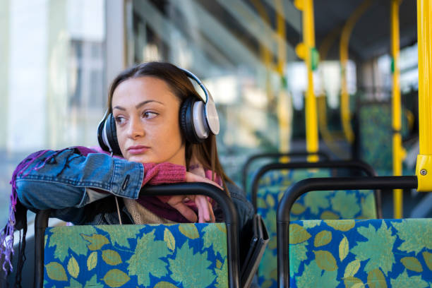 istock A beautiful young woman in public transport. 1284811439