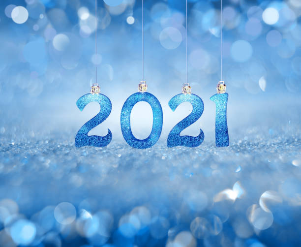 Glowing blurred blue background. Festive winter concept. 2021.