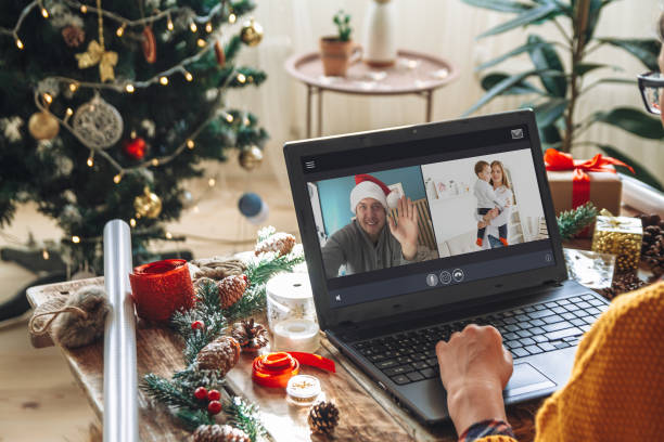 istock young woman with laptop over Christmas tree background 1284811738