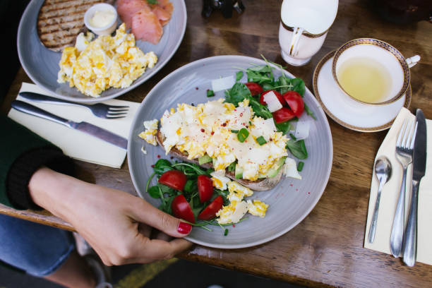 istock hand holding brunch plates at a restaurant 1284813264