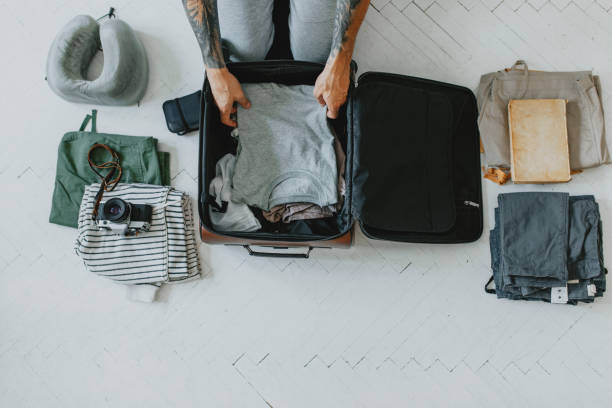istock Anonymous Young Man Packing up the Essentials for a Weekend City Break 1284813486