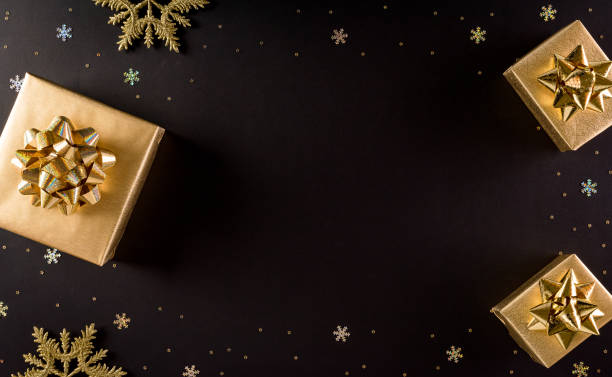 istock Top view of golden christmas boxes on black background with copy space for text. Black Friday Sale, Banner, poster composition. 1284815057