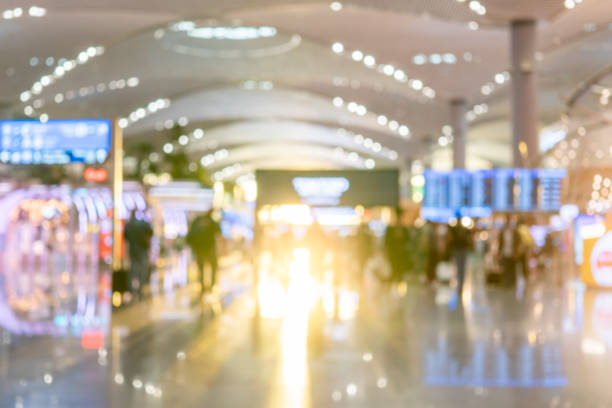 istock Blurred background with bokeh light in empty airport due to coronavirus covid new normal rule shop store area runway  escalator with travel passenger fly flight travel walking in  hallway in terminal 1284815873