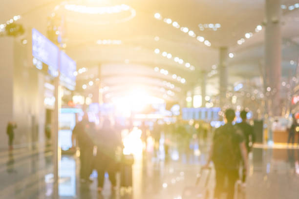 istock Blurred background with bokeh light in empty airport due to coronavirus covid new normal rule shop store area runway  escalator with travel passenger fly flight travel walking in  hallway in terminal 1284815892