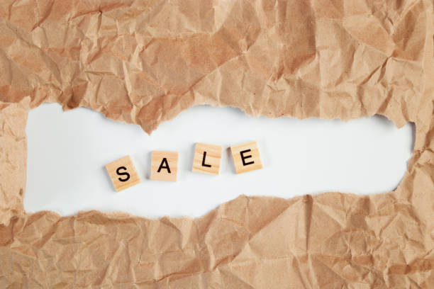 istock Black Friday sale. Text in torn craft paper. 1284816939
