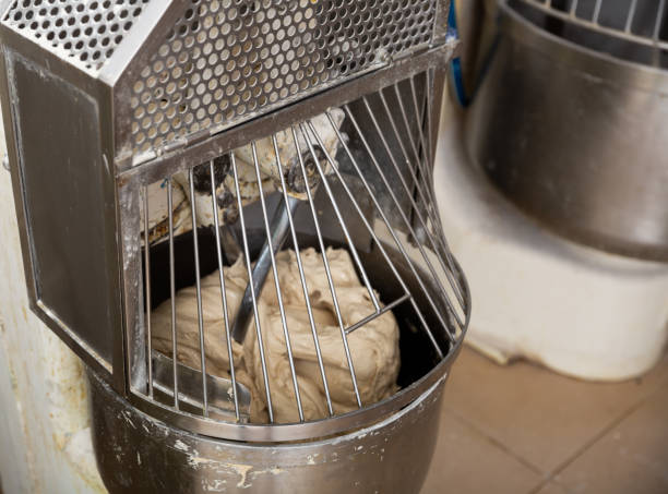 istock Baker preparing the dough for bread in a dough mixer 1284817059
