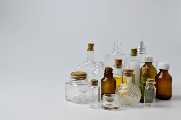 istock Empty glass bottles on a light background. Various vessels for cosmetics and medicines. 1284818397