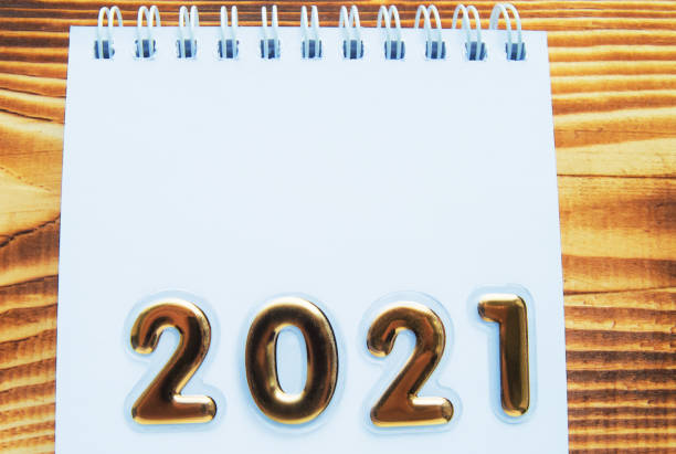 istock Happy New year layout, numbers with Golden numbers 2021 Notepad and free space for text, background-wooden Board 1284819314