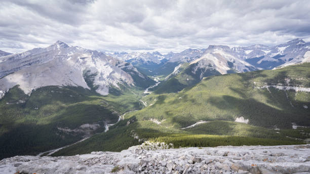 istock View on beautiful alpine valley from mountain summit with dramatic cloudy sky 1284819430