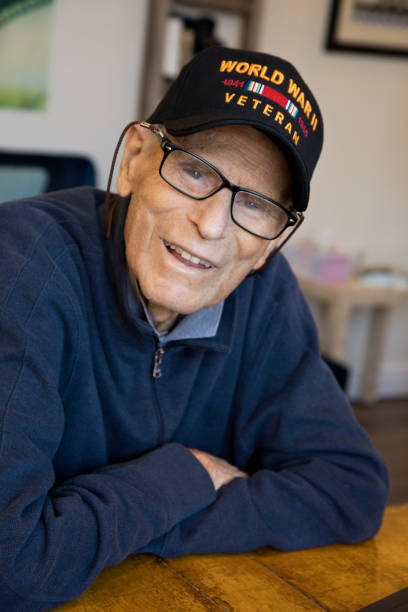 istock World War Two Veteran wearing cap at home smiling looking at camera 1284820063