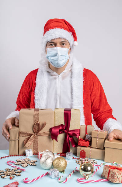 istock Man dressed as Santa Claus with surgical mask 1284821994
